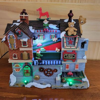 Holiday Collection,Christmas Village, L.E.D. Lightup, Musical, Polyresin SantaToy Shop w/ Motion, 8